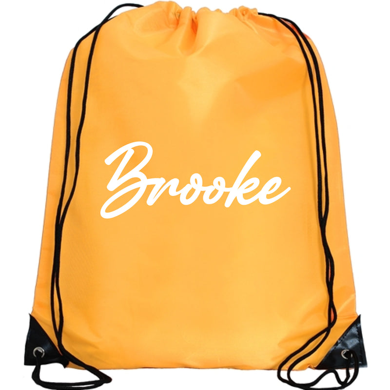 A bright yellow drawstring bag with the name "Brooke" printed on it in white cursive font.
