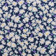 a pattern of white daisies with yellow centers against a dark blue background.