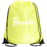 A yellow drawstring bag with the name "Brooke" printed on it in white cursive font.