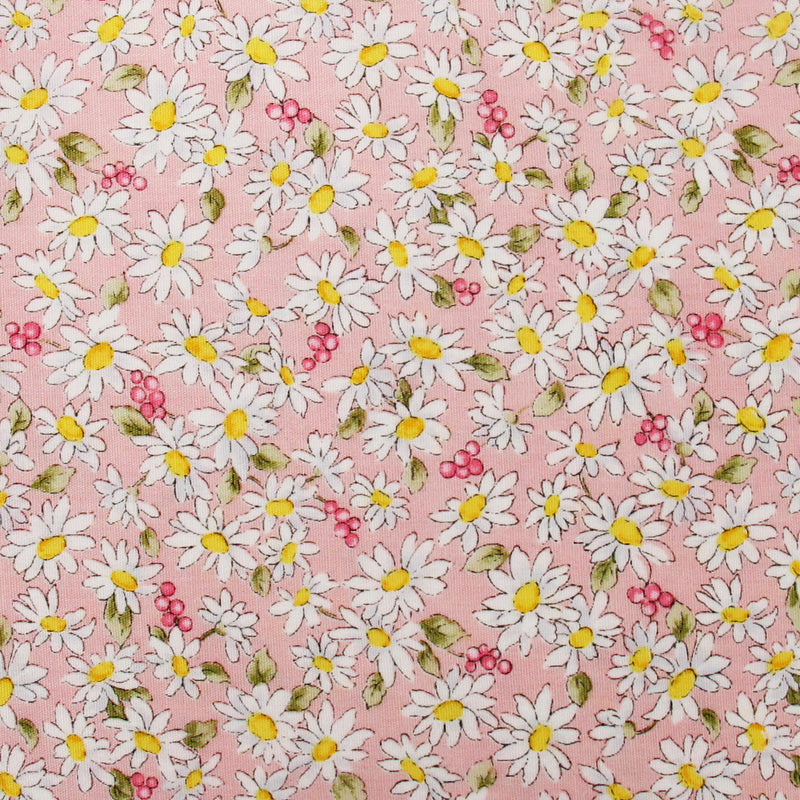a pattern of white and yellow daisies with green leaves scattered throughout a pink background.
