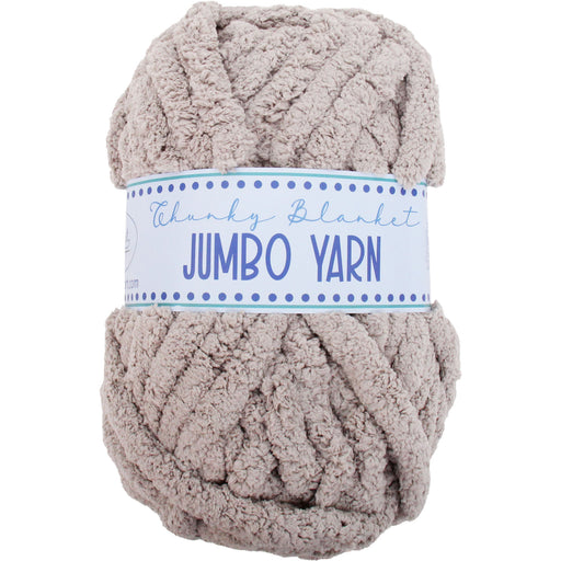A ball of chunky, light brown yarn labeled as "Jumbo Yarn" is shown against a white background.