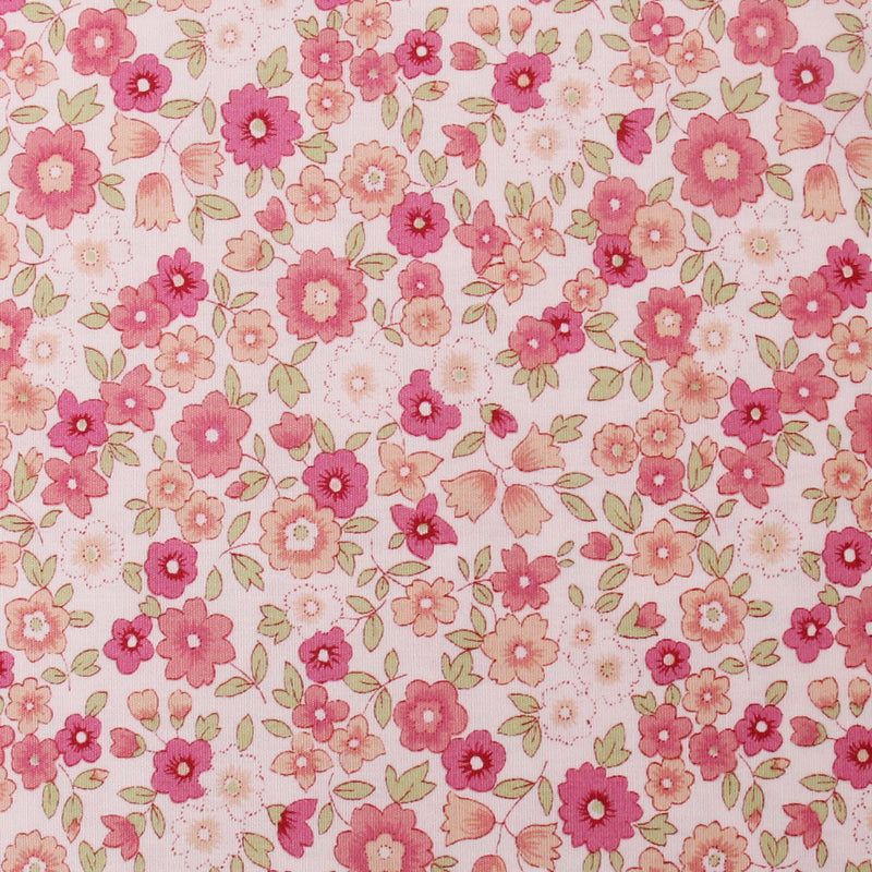 a pattern of pink and white flowers with green leaves, creating a visually appealing and vibrant design.