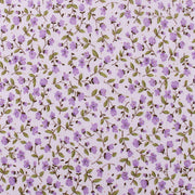 a repeating pattern of purple flowers and green leaves on a light pink background.