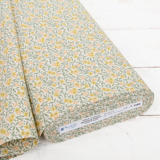 a roll of fabric with a floral print pattern, placed on a white wooden surface.