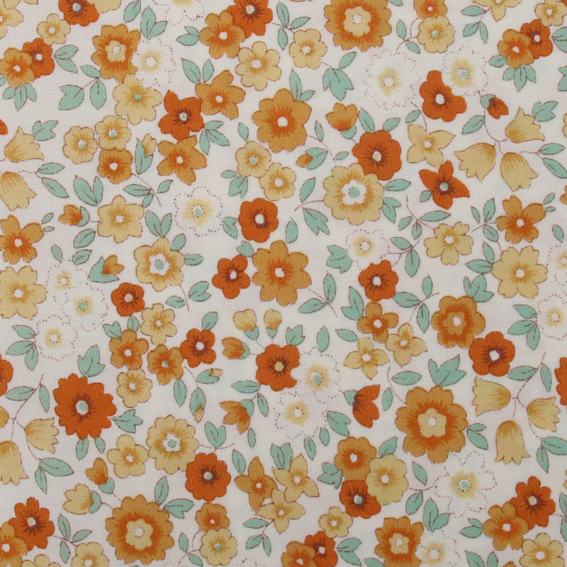 The image is a close-up of a fabric with a floral pattern of orange and yellow flowers and green leaves.