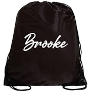 A black drawstring bag with the name "Brooke" printed in white on it.