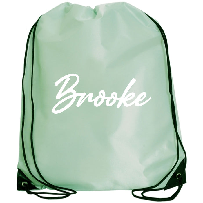 A mint green drawstring backpack with the name "Brooke" printed on it in white cursive text.