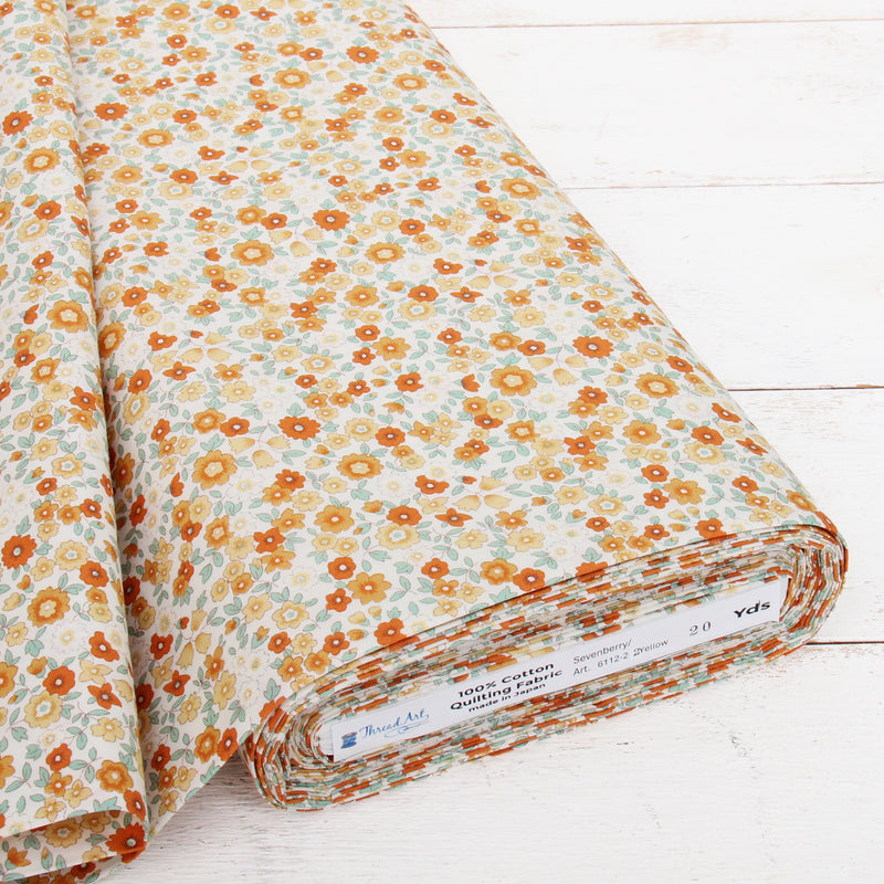 A roll of fabric with a floral print pattern in shades of orange and white.