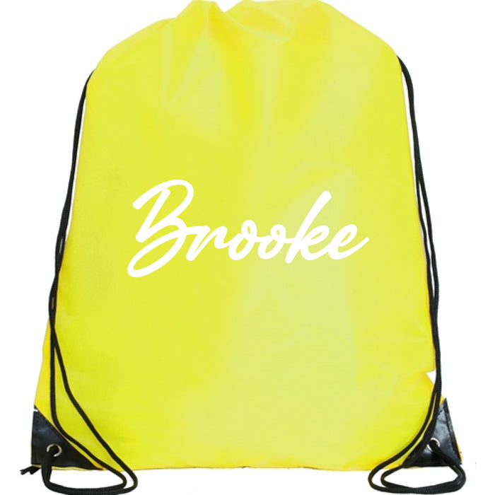 A yellow drawstring bag with the name "Brooke" printed on it in white text.