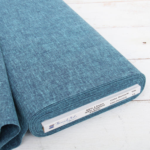 Peacock blue yarn dyed homespun cotton linen blend fabric on the bolt