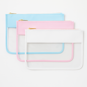 Light blue, light pink, and white clear zipper pouch bags stacked on a white background