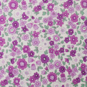 a pattern of purple flowers with green leaves, creating a visually appealing and vibrant design.