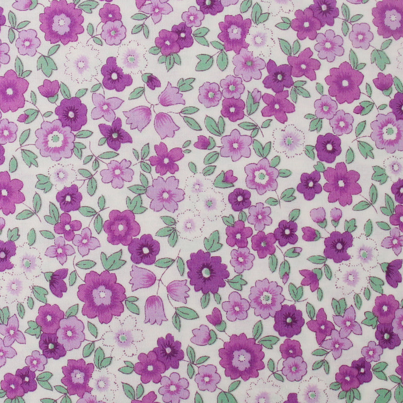 a pattern of purple flowers with green leaves, creating a visually appealing and vibrant design.