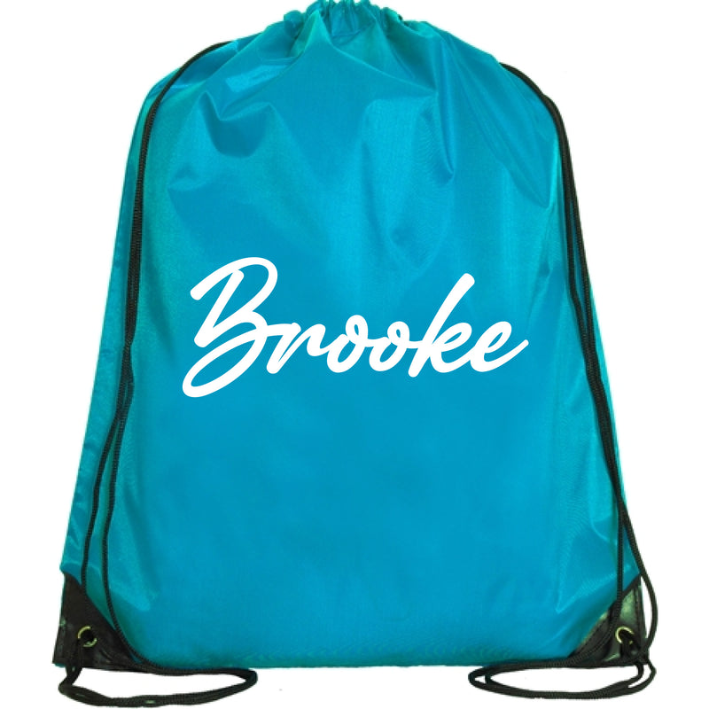 A turquoise backpack with the name "Brooke" printed on it in white text.