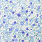 a pattern of blue and white flowers with green leaves, creating a visually appealing and harmonious design.