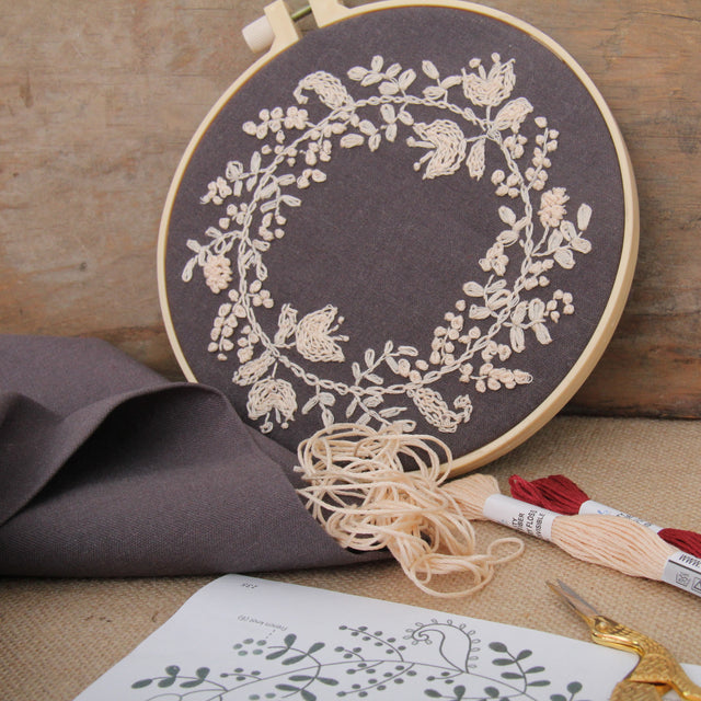 Cream floral wreath on charcoal linen