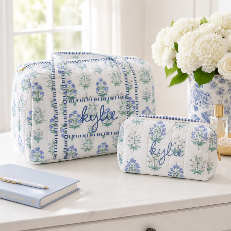 Personalized quilted blue block print weekend duffel and matching zipper pouch set embroidered with a name