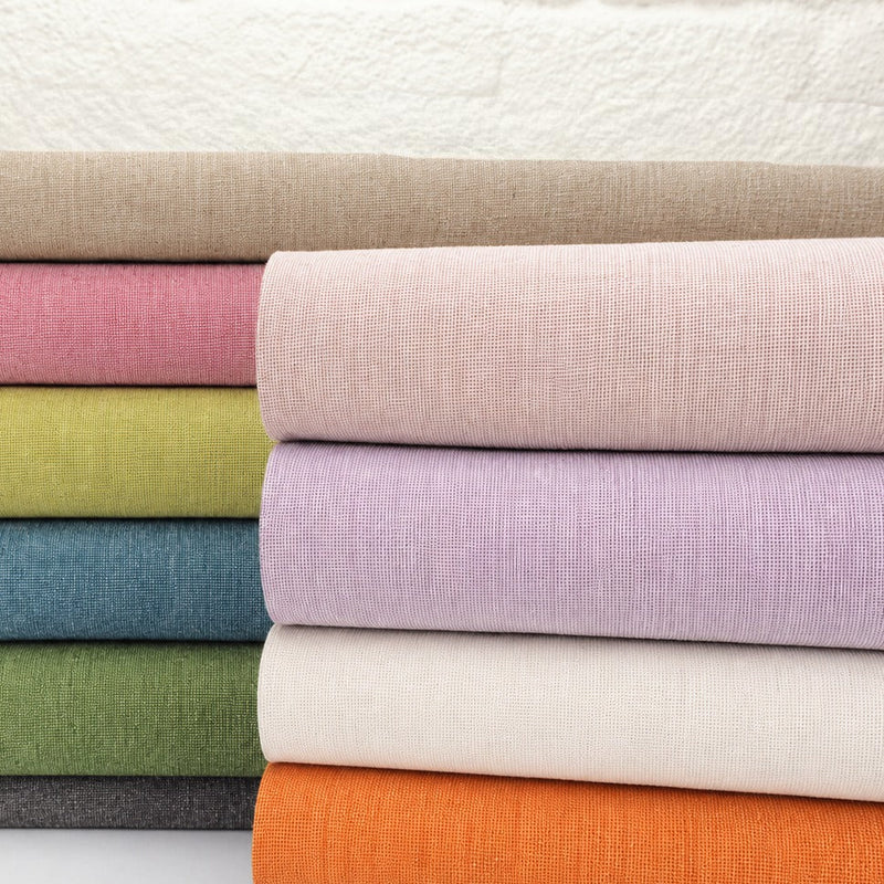 Stack of yarn dyed homespun linen fabric in the full range of colors